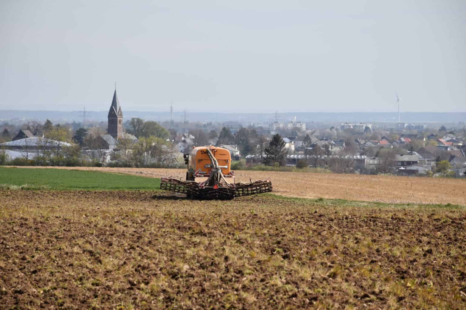 Ein Trecker mit Gülleanhänger auf einem Feld